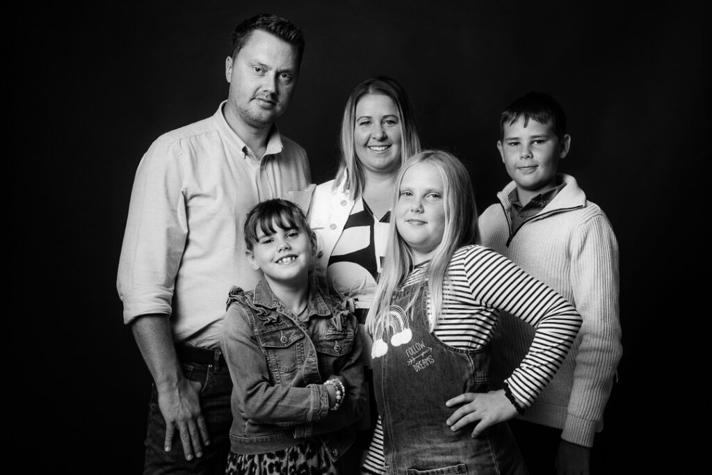 Timeless black and white family portrait taken at a photography studio in Monmouthshire.