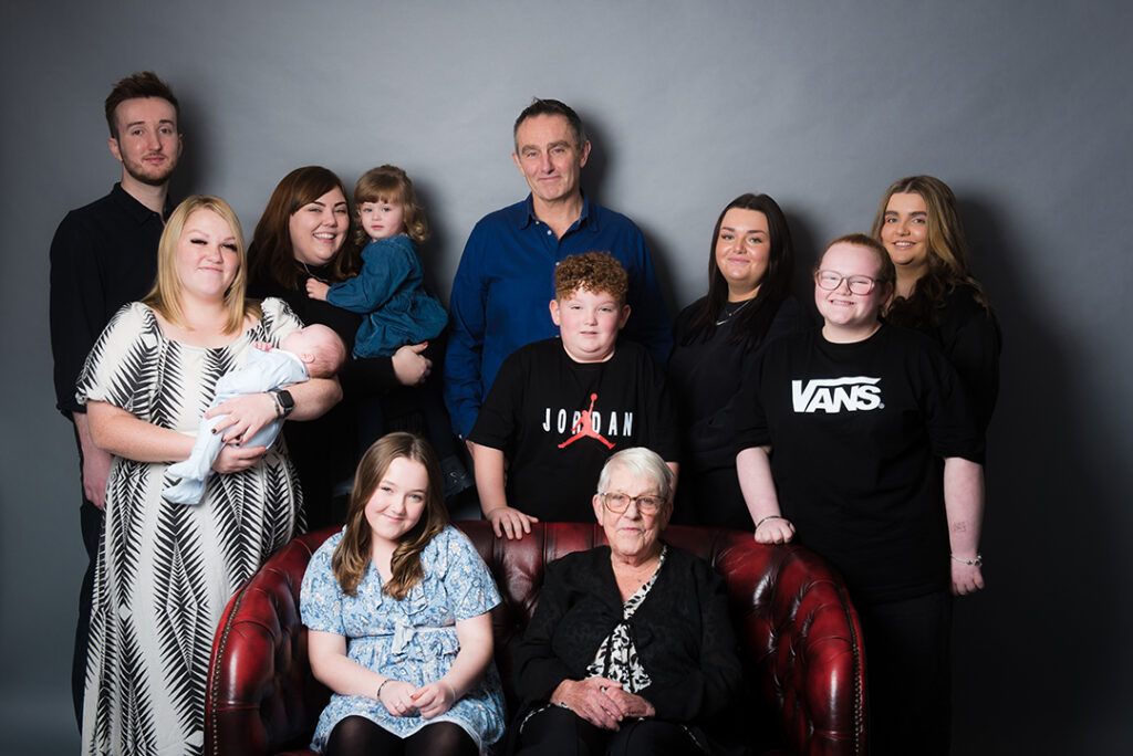 Natural family photo showing three generations together in a relaxed and joyful moment