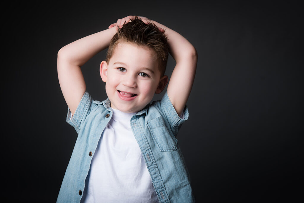 "A smiling child during a relaxed portrait session at Stables Photography Studios in Abergavenny, South Wales"