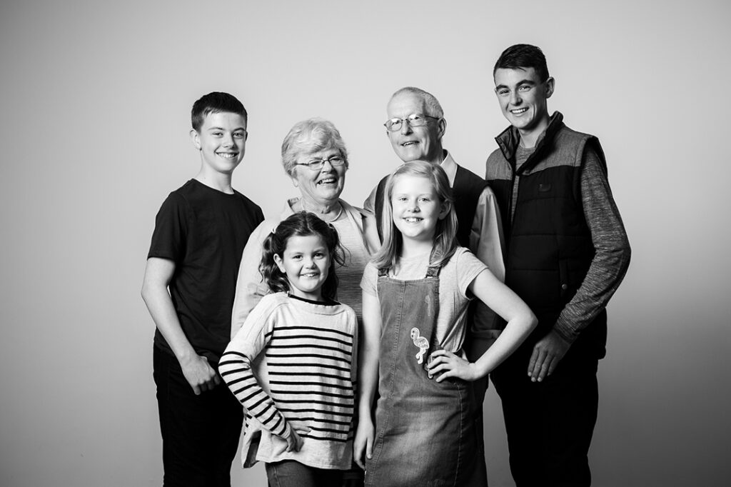 Grandparents with young grandchildren during a relaxed family photo session near Abergavenny