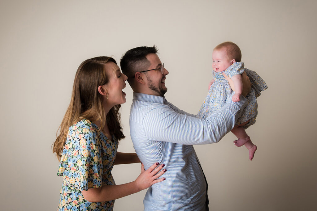 hree-month-old baby cuddled in parents’ arms at Monmouthshire portrait studio